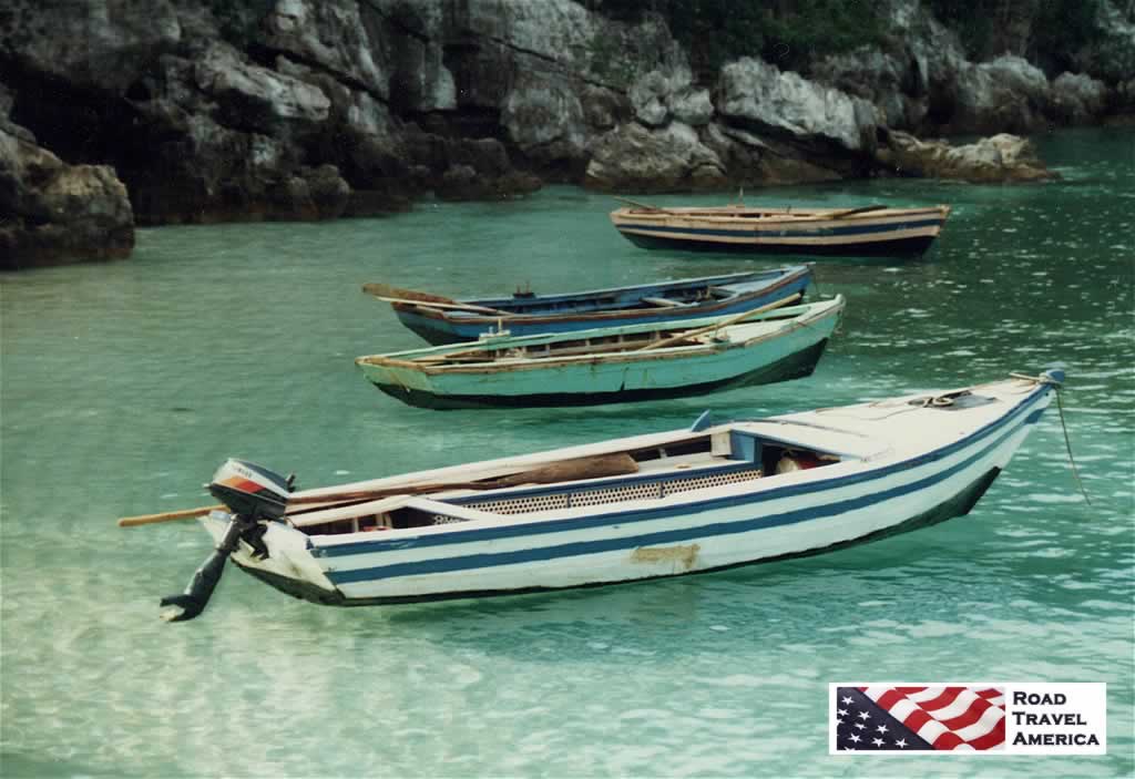Wooden boats at anchor in the green waters at Labadee, Haiti